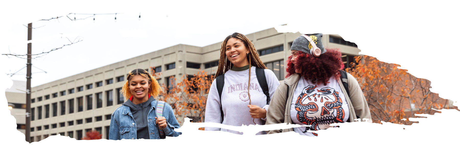 three students smiling and walking on the IU Indianapolis campus