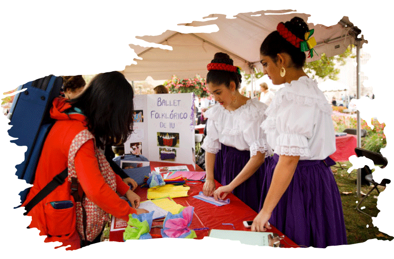 Two women in traditional dress tabling at an event