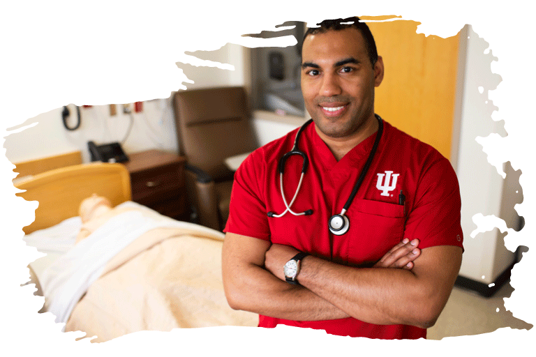 A male student nurse standing in a hospital