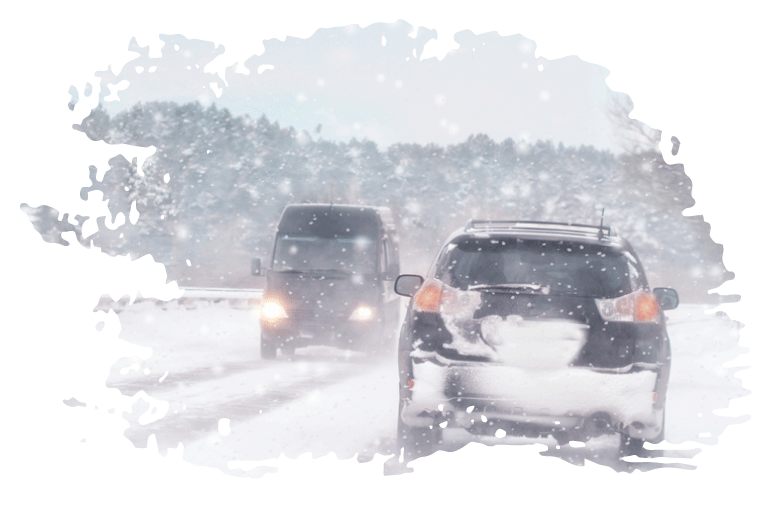 two vehicles driving in a winter storm